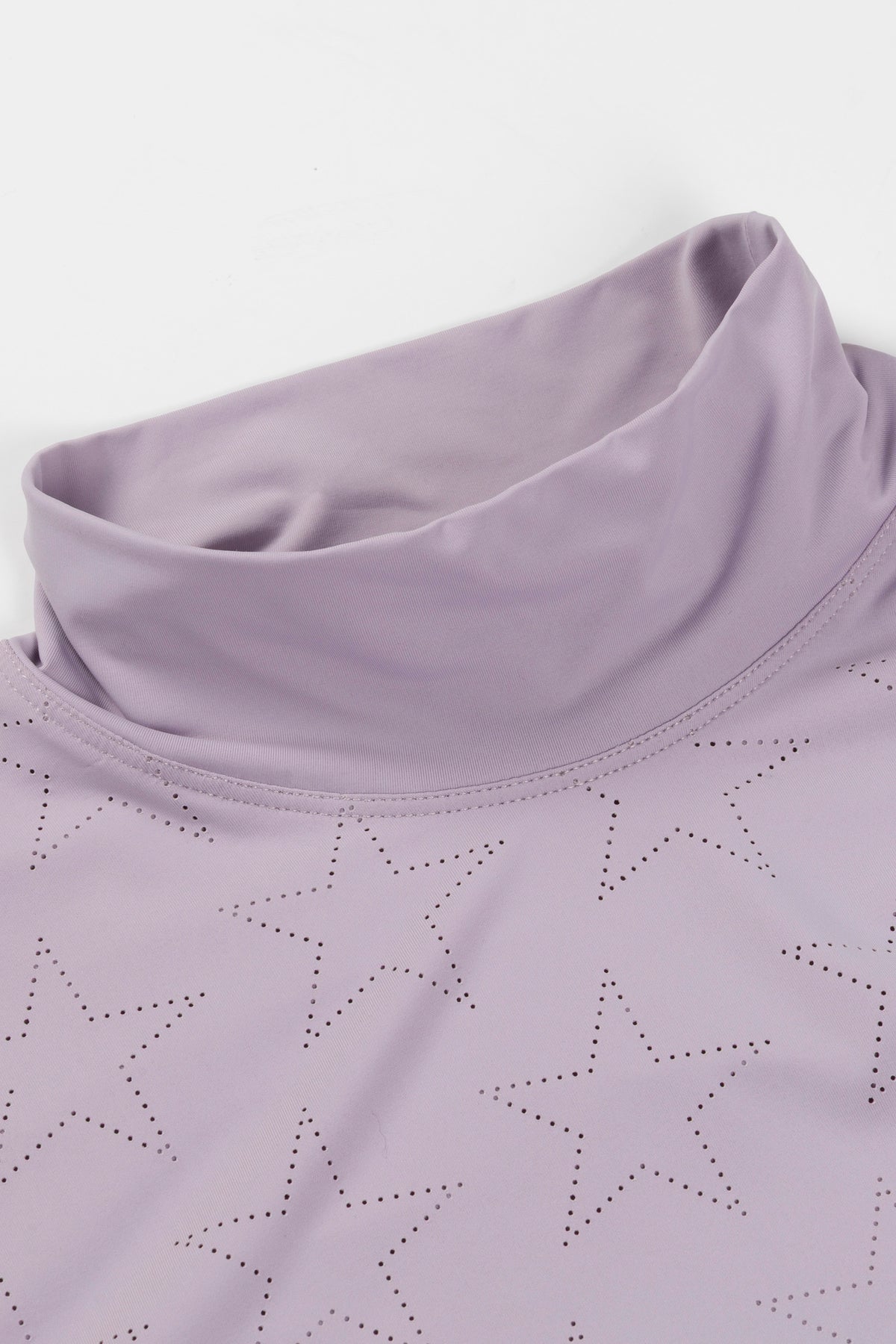 Hannah Childs Farrah Star turtleneck training top in Thistle with perforated star pattern